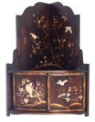 A late 19th/early 20th Century Japanese Shibyama decorated bow-fronted hanging corner cabinet,