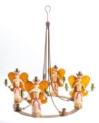A wrought iron and carved and painted wood mounted sixteen light chandelier,