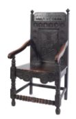 A carved oak wainscot elbow chair in late 17th century style,