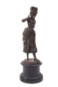 A Continental bronze model of a maiden, late 19th century; portrayed as standing, in period attire,