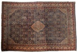 A Hamadan carpet, the indigo field with an all over design of stylised flowerheads and foliage,