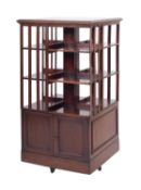 An Edwardian mahogany square revolving bookcase, with a moulded top and slatted sides,