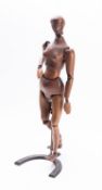 A stained beechwood articulated lay female figure, early 20th century; with metal hinged joints,