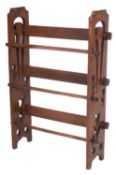 An oak three tier open book trough in the Arts and Crafts manner,