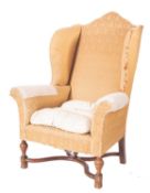 A stained beech and walnut wing frame armchair in the late 17th Century style,