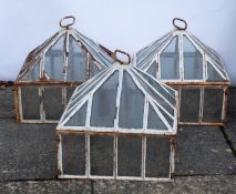 Three Victorian cast iron and glazed garden cloches, late 19th century; with removable top sections,