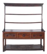 An early 19th Century oak and inlaid dresser, the shelved superstructure with a moulded cornice,
