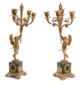 A pair of Empire gilt and patinated bronze four light figural candelabra,