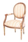 A carved giltwood and reddened fauteuil in the Louis XV/XVI transitional taste,