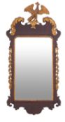 A walnut and parcel gilt framed wall mirror in George II style,