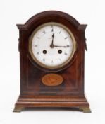 An Edwardian French mantel clock with shell inlaid decoration the eight-day duration movement