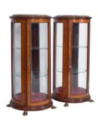 A pair of mahogany, crossbanded and glazed cylindrical vitrines,