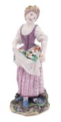 A Champion's Bristol figure of a girl her hair tied with a yellow ribbon and holding flowers in the