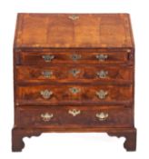 A George I walnut cross and feather banded bureau,