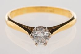 A diamond solitaire ring, set with a bri