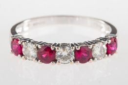 An 18ct gold ruby & diamond half eternit