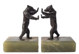 A pair of onyx mounted metal bookends in the form of standing bears, in Art Deco taste,