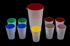 A mid 20th century red and white cased glass jug 17.6cms. high and nine multicoloured beakers, 8.