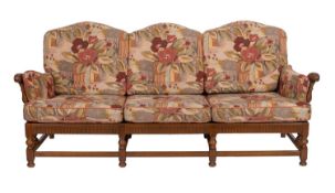 An elm and upholstered suite, by Ercol, late 20th century; the three-seat settee and one armchair
