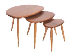 A nest of three Ercol stained elm 'Pebble' tables,