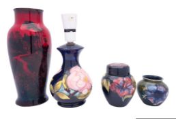 Two pieces of Walter Moorcroft pottery, comprising a small vase tube lined in the Anemone pattern,