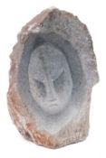 An African soapstone or steatite sculpture in the form of a stylised visage, signed J.