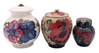 A Moorcroft pottery lamp and two jars and covers,