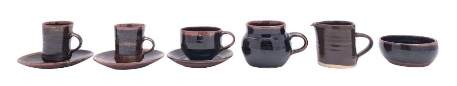 A group of Winchcombe and other stoneware, comprising two coffee cups and saucers,