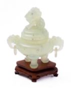 A Chinese carved green hardstone tripod