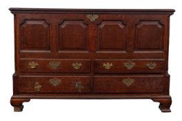 An 18th Century oak mule chest, with a rectangular hinged moulded top,