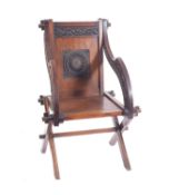 A Victorian carved oak Glastonbury chair