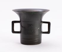 A bronze two-handled mortar inscribed 'B