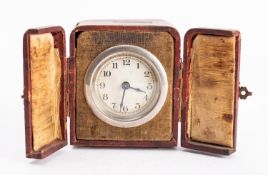 A leather cased travelling clock with an