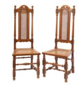 A pair of carved oak and canework side c