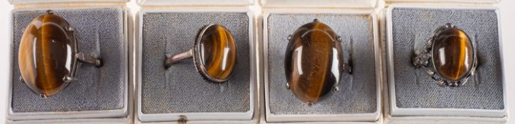 A group of eleven stone set rings, including smokey quartz, moss agate, tiger's eye,