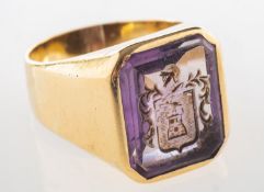 An amethyst intaglio ring with family crest,