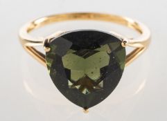 A 9ct gold moldavite single stone ring, claw set with a triangular-cut moldavite, approx. 4.