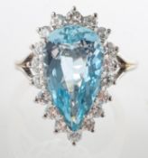 An aquamarine and diamond cluster ring, claw set with a pear-shaped aquamarine, aquamarine approx.