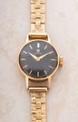 Omega a lady's 9ct gold wristwatch the round black dial having Dauphine hands,