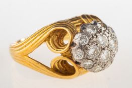 A modern diamond cluster ring, of bi-colour,
