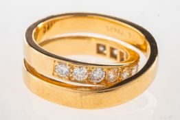 Cartier. A Nouvelle Vague diamond crossover ring, set with eleven brilliant-cut diamonds,