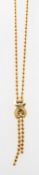 An 18ct gold beaded lariat necklace, a lariat necklace of beaded chain,