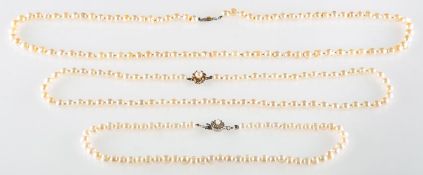 A group of three pearl necklaces,