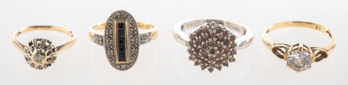 A group of four rings, including a 9ct gold oval shaped ring,