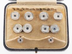 A set of Art Deco mother of pearl and sapphire buttons, cufflinks and shirt studs, of circular form,