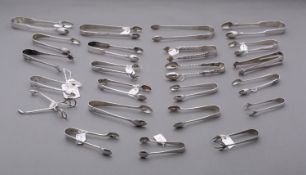 A mixed group of silver sugar tongs including;