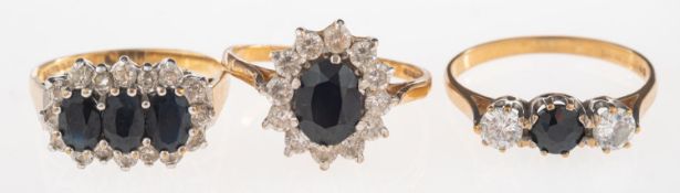 A group of three 9ct gold sapphire rings,