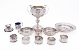 A mixed group of silver including; a North Hants two handled trophy cup, six various napkin rings,