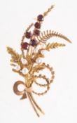 A 1970's 9ct gold garnet and pearl leaf spray brooch,