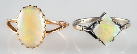 Two opal rings, including a split shoulder ring claw set with an oval opal cabochon,